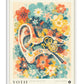 White-framed Auris in Bloom art print featuring a stylized ear surrounded by teal, coral, yellow, and navy flowers.