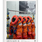 White-framed Artemis II art print showing five orange crew suits with NASA, United States, and Canadian patches.