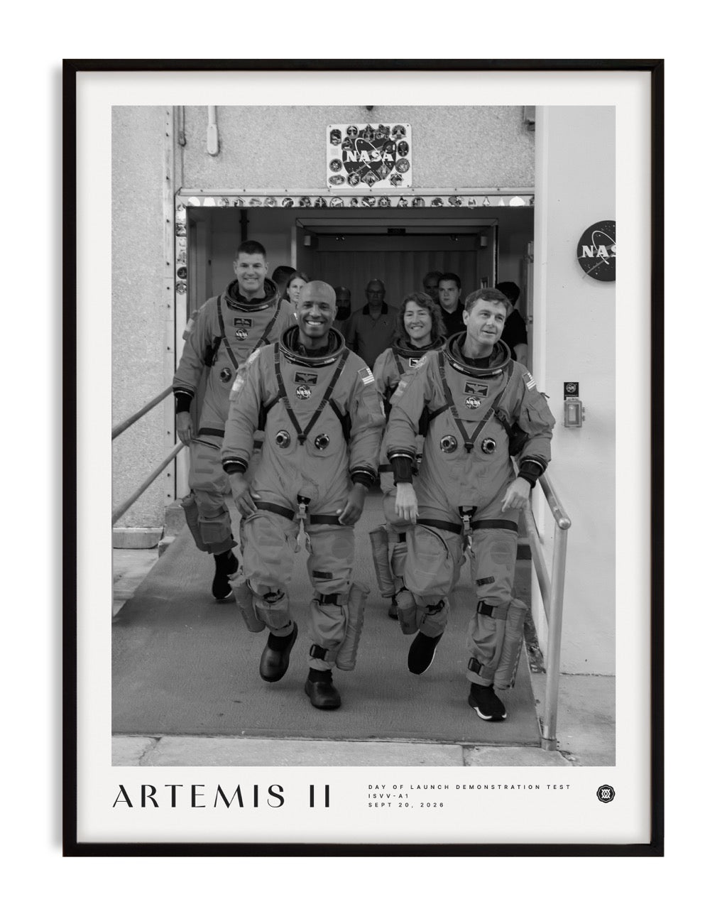 Black-framed Artemis II crew art print featuring four astronauts in spacesuits walking out of a NASA building.