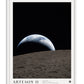 White-framed Artemis II Earthset art print showing a crescent Earth rising above the Moon.