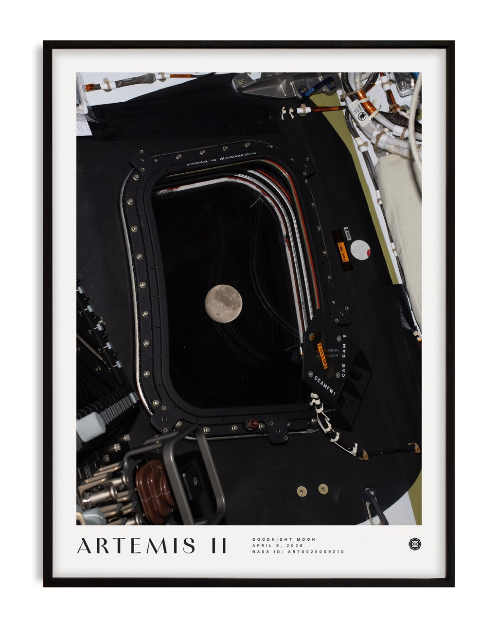 Black-framed Artemis II Goodnight Moon art print showing the Moon through a spacecraft window surrounded by equipment.