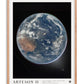 Oak-framed Artemis II art print showing Earth against black space, with Australia visible beneath swirling clouds.