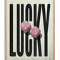 Oak-framed LUCKY art print featuring oversized black lettering and two pink fuzzy dice.