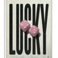 White-framed LUCKY art print featuring oversized black lettering and two pink fuzzy dice.