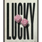 Black-framed Lucky artwork with oversized black lettering and two fuzzy pink dice on a textured cream background.
