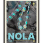 Black-framed NOLA 1857 Mardi Gras art print featuring iridescent bead strands and a fleur-de-lis over grayscale fabric.
