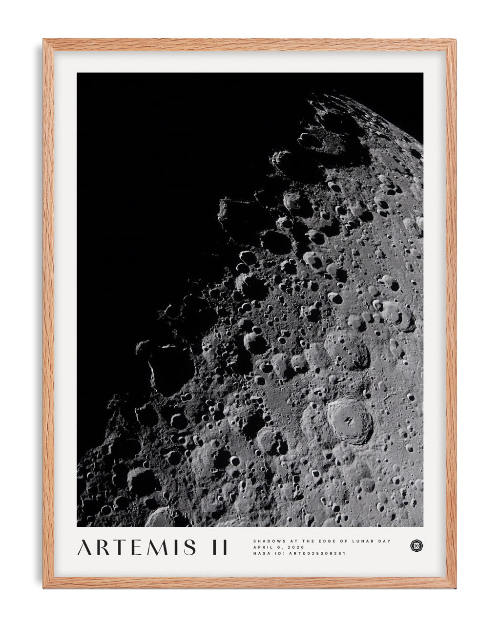 Oak-framed Artemis II art print featuring a black-and-white view of the Moon’s cratered surface against black space.