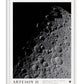 White-framed Artemis II art print featuring a black-and-white view of the Moon’s cratered surface against black space.