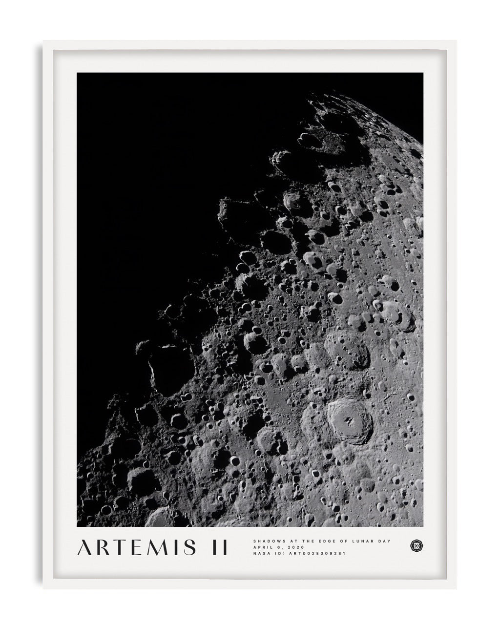 White-framed Artemis II art print featuring a black-and-white view of the Moon’s cratered surface against black space.