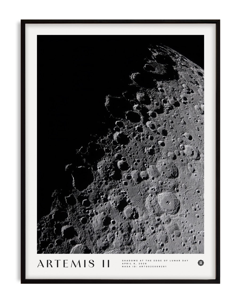 Black-framed Artemis II Shadows at the Edge of Lunar Day art print showing cratered terrain emerging from deep shadow.