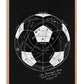 Oak-framed black artwork featuring a white technical soccer ball diagram and handwritten text about the 1930 World Cup opening day.