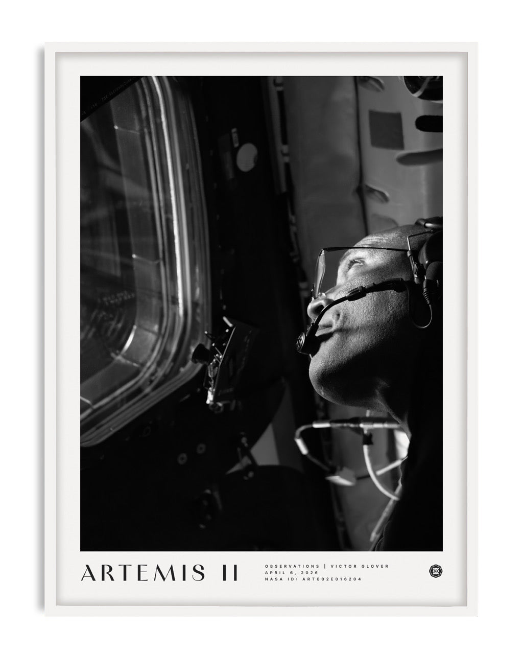 White-framed Artemis II art print showing a black-and-white portrait of an astronaut wearing a headset beside a spacecraft window.