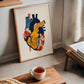 Framed abstract painting of the human heart, leaning against wall in living room