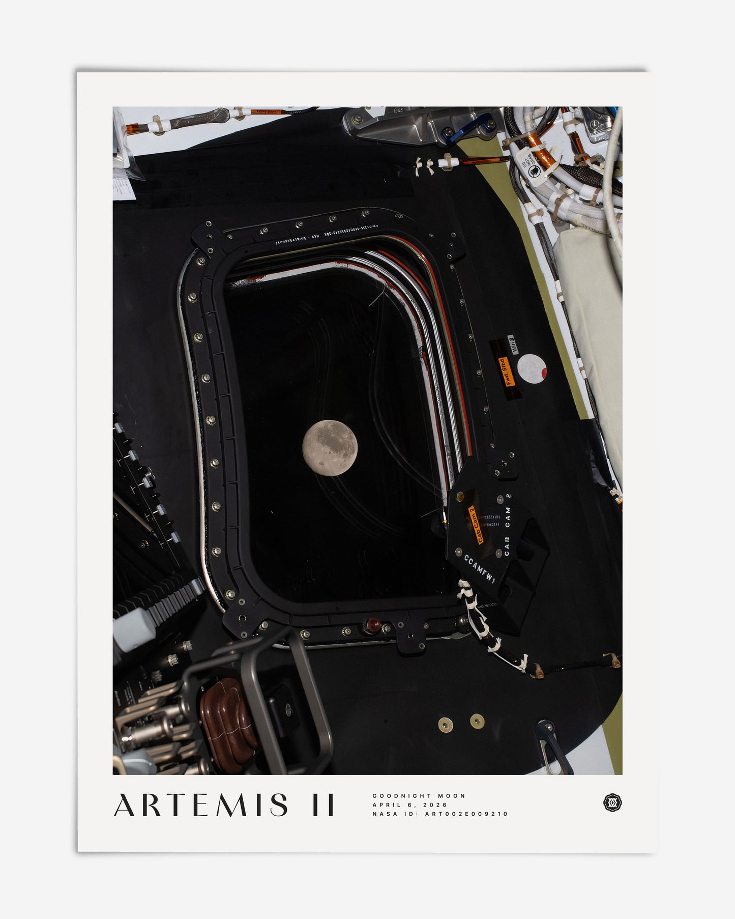 Unframed Artemis II Goodnight Moon art print showing the Moon through a spacecraft window surrounded by cables and equipment.
