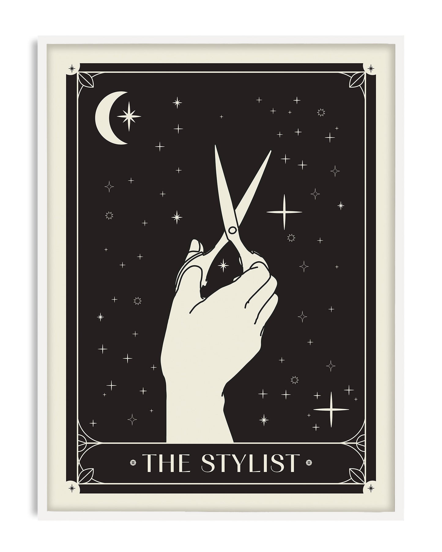 White-framed The Stylist art print featuring a hand holding scissors among a crescent moon and stars.