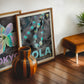 Oak-framed NOLA Mardi Gras bead artwork displayed in an interior setting.