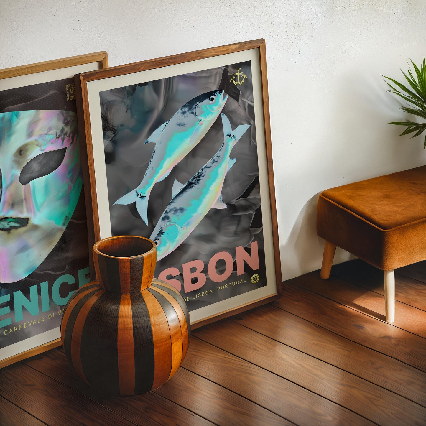 Dark wood-framed Lisbon artwork featuring two iridescent fish, displayed with another framed print and a striped wooden vase.