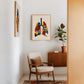 Oak-framed colorful lung anatomy artwork displayed above an armchair beside a potted plant.