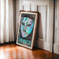 Dark wood-framed Venice 1296 artwork featuring an iridescent carnival mask leaning against paneled walls by a window.