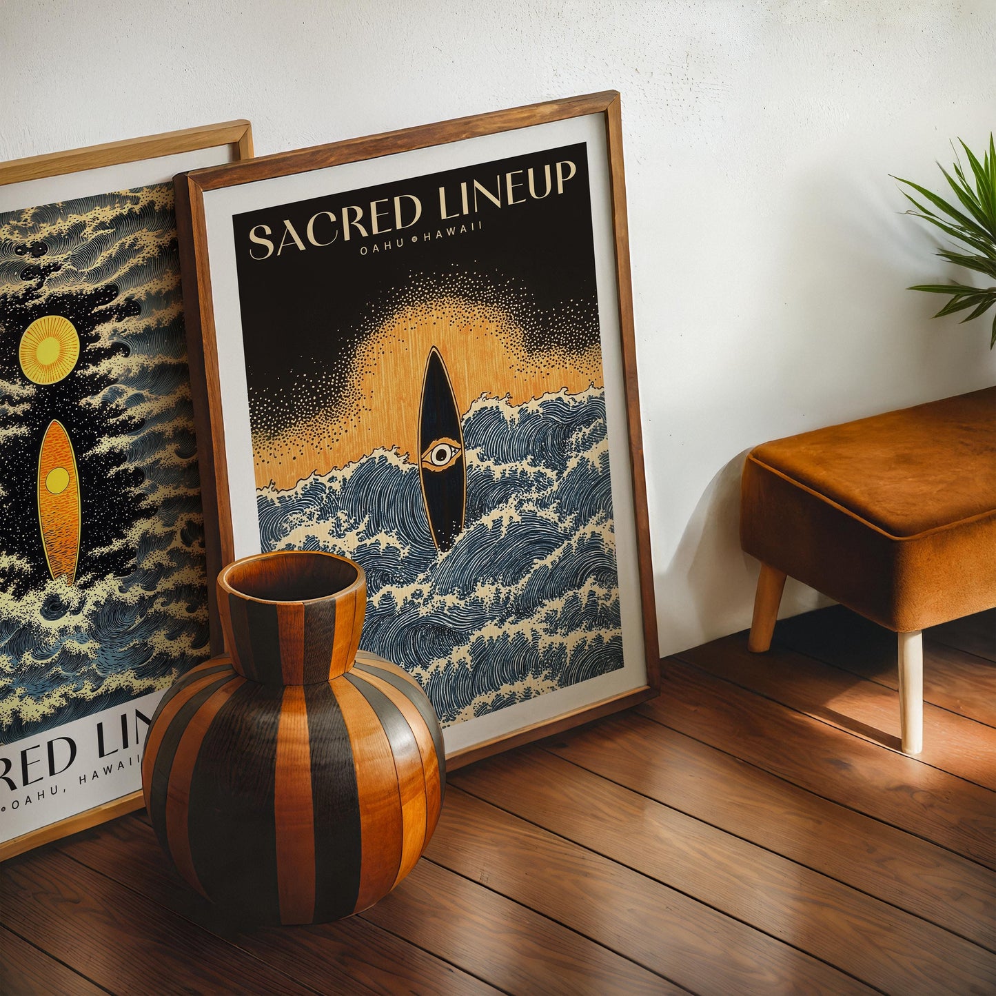 Oak-framed Sacred Lineup Oahu Hawaii artwork displayed on a wooden floor with another art print, a striped vase, and a chair.