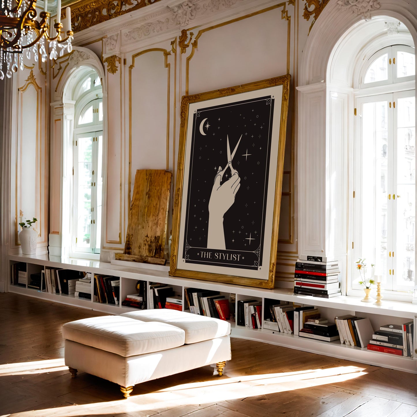 Ornate gold-framed The Stylist art print with a hand holding scissors, displayed in an elegant sunlit library.