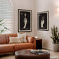 Black-framed The Colorist and The Stylist artworks displayed above a tan leather sofa in a living room.