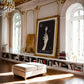 Ornate gold-framed The Colorist artwork displayed above bookshelves in a bright room with arched windows and gilded details.