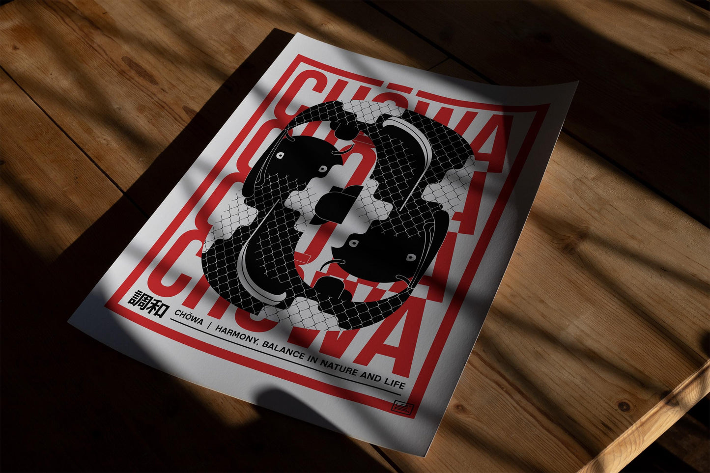 Unframed red, black, and white Chōwa koi fish art print resting on a sunlit wooden table.
