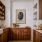 Framed Costa Rica coffee origins artwork featuring a black-and-white coffee bean displayed in a wood-accented kitchen.