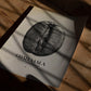 Unframed Guatemala coffee origins art print featuring a black-and-white coffee bean lying on a wooden floor in patterned sunlight.