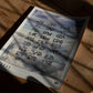 Unframed Sky Codes art print with airport abbreviations over painted clouds, lying on a wooden table in patterned sunlight.