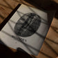 Unframed Sumatra Aceh, Lintong coffee bean art print lying on a wooden table beneath window shadows.