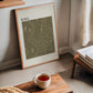 Oak-framed HIKE. map-style artwork leaning by a window beside books and a cup of tea.