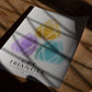 Unframed CBT Triangle art print with yellow, purple, and teal forms lying on a sunlit wooden floor.