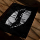 Unframed Clippers art print lying on a wooden table in dappled light.