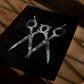 Unframed black and white scissors art print lying on a sunlit wooden table.