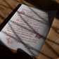 Unframed art print with red handwritten dining advice and food illustrations resting on a sunlit wooden table.