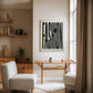 Oak-framed FASHION typography artwork with button and thread displayed above a wooden console table.