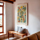Framed floral anatomy artwork displayed above a bench in a sunlit room.