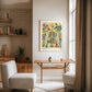 Framed floral anatomy artwork displayed above a narrow table in a reading nook.