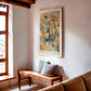 Light wood-framed Cerebrum in Bloom art print displayed above a wooden bench near a window.