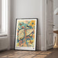Black-framed Hepar in Bloom artwork leaning on the floor in a bright room beside a window and doorway.