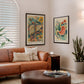 Black-framed anatomical liver and stomach artworks displayed above a leather sofa in a living room.