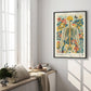 Black-framed floral anatomy artwork displayed beside tall windows in a bright interior.