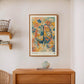 Dark wood-framed Cerebrum in Bloom art print displayed above a wooden cabinet and blue patterned vase.