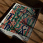 Unframed colorful legal-themed art print resting on a sunlit wooden table.