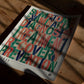 Unframed medical process art print with colorful stacked typography lying on a wooden table in dappled sunlight.