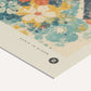 Close-up of the Auris in Bloom art print showing textured teal and yellow flowers, title text, and emblem.
