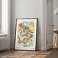 Black-framed Auris in Bloom ear and floral artwork leaning beside a window and open doorway.