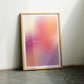 Oak-framed “This is my happy place” gradient art print leaning on a dark floor between two chairs.